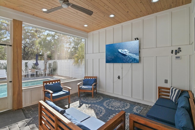 sunroom / solarium with ceiling fan and wooden ceiling