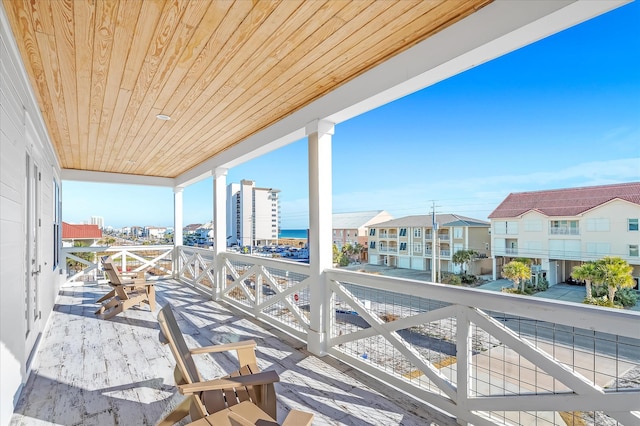 view of patio with a water view and a balcony