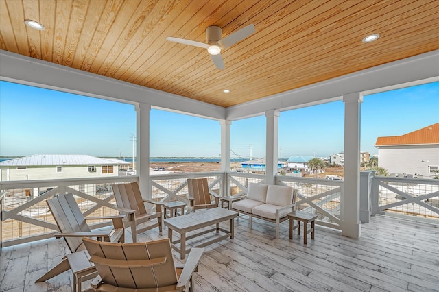 wooden terrace with an outdoor hangout area and ceiling fan