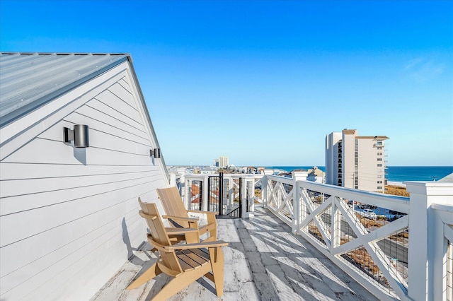 wooden terrace featuring a water view