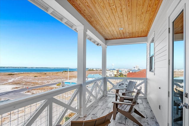 balcony with a water view and a beach view