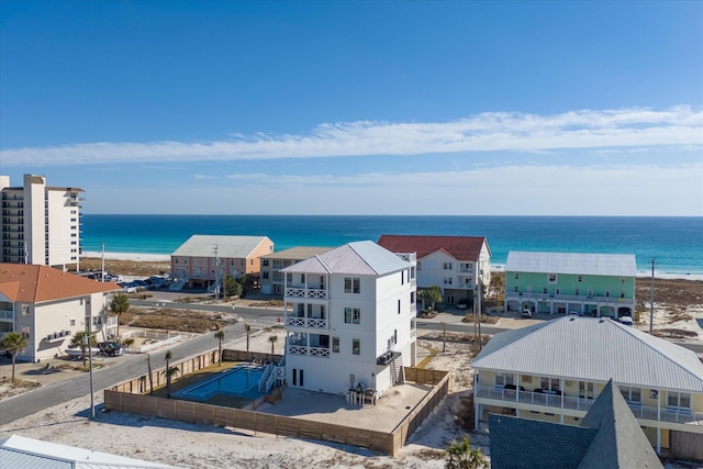 birds eye view of property featuring a water view and a beach view