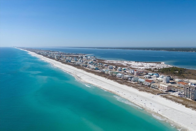 birds eye view of property with a water view and a beach view