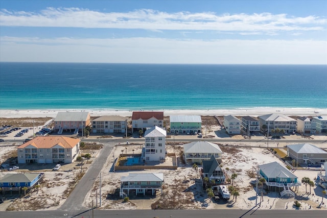 drone / aerial view with a water view and a view of the beach