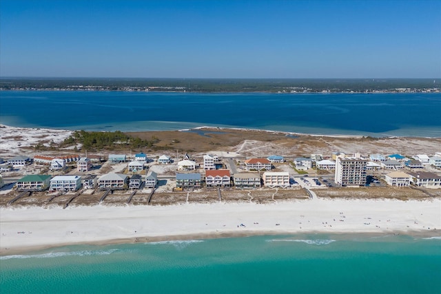 bird's eye view featuring a water view and a view of the beach