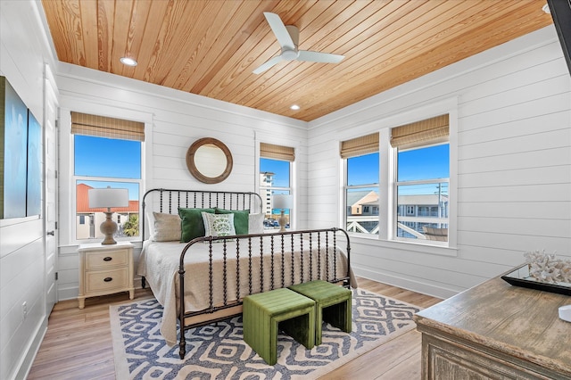 bedroom featuring multiple windows, wooden ceiling, and light hardwood / wood-style floors