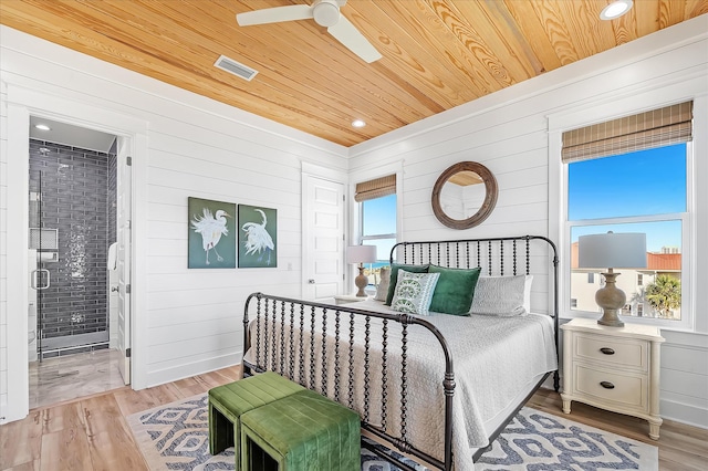 bedroom featuring multiple windows, wood ceiling, and light hardwood / wood-style floors