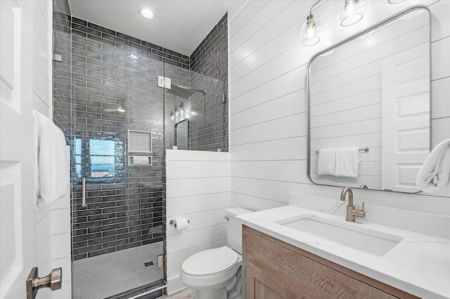 bathroom featuring vanity, an enclosed shower, and toilet