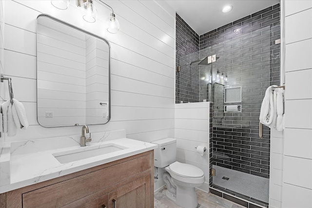 bathroom with vanity, toilet, and a shower with shower door