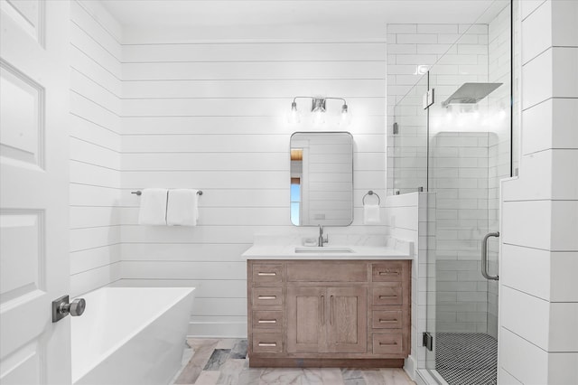 bathroom featuring vanity and independent shower and bath