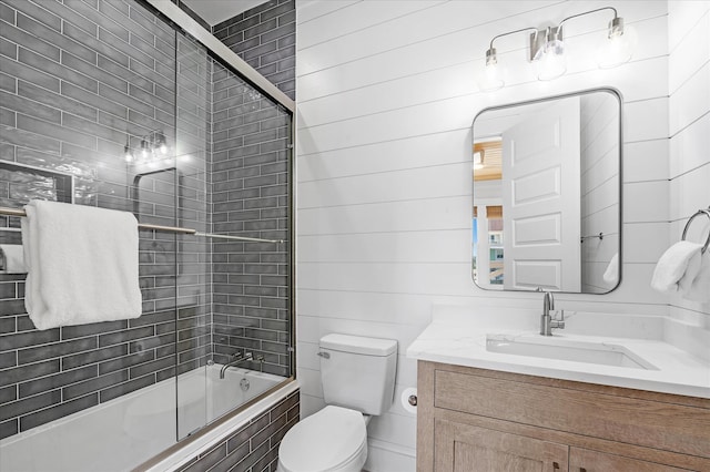 full bathroom with vanity, combined bath / shower with glass door, and toilet