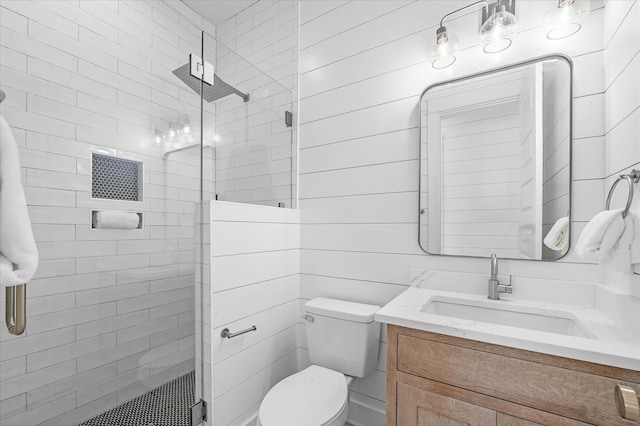 bathroom featuring vanity, toilet, and an enclosed shower