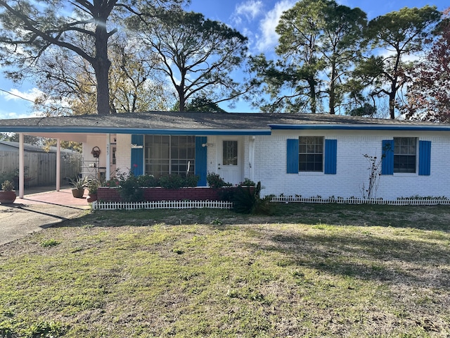 single story home featuring a carport and a front lawn