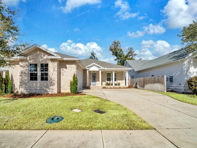 single story home featuring a porch and a front lawn