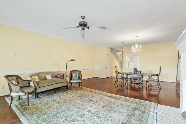 living room with crown molding, ceiling fan with notable chandelier, and dark hardwood / wood-style flooring