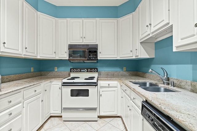 kitchen with sink, white appliances, light tile patterned floors, light stone counters, and white cabinets