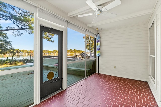 unfurnished sunroom with beam ceiling, ceiling fan, and a water view