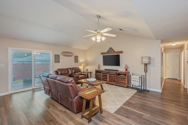 living room featuring hardwood / wood-style flooring, ceiling fan, lofted ceiling, and a textured ceiling