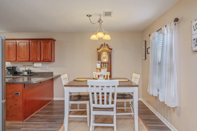 dining area featuring dark wood-type flooring