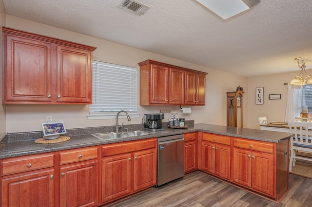 kitchen featuring sink, a textured ceiling, dishwasher, kitchen peninsula, and hardwood / wood-style flooring