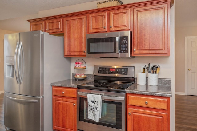 kitchen with dark hardwood / wood-style flooring and appliances with stainless steel finishes