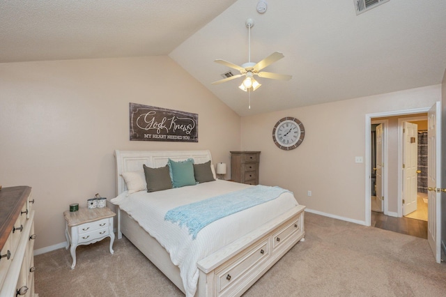 carpeted bedroom with ceiling fan and vaulted ceiling