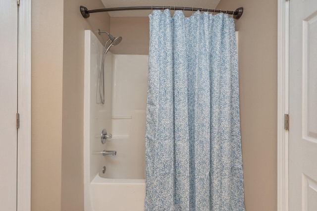 bathroom featuring a textured ceiling and shower / bath combo with shower curtain