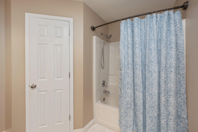 bathroom featuring a textured ceiling and shower / bath combo with shower curtain