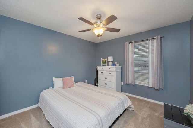 carpeted bedroom with a textured ceiling and ceiling fan