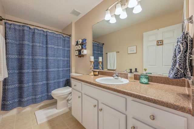 bathroom featuring vanity, toilet, and a textured ceiling