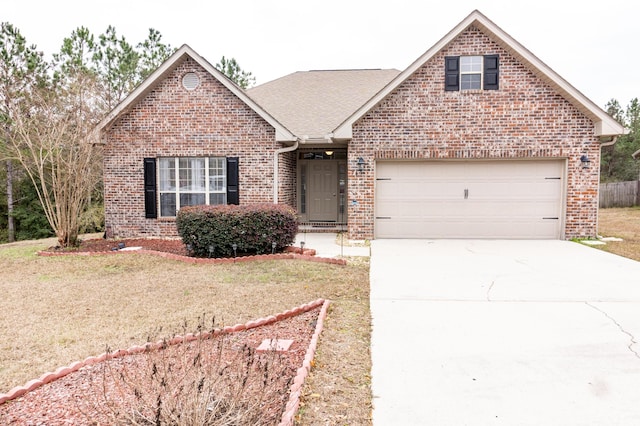 view of front of property with a garage and a front lawn