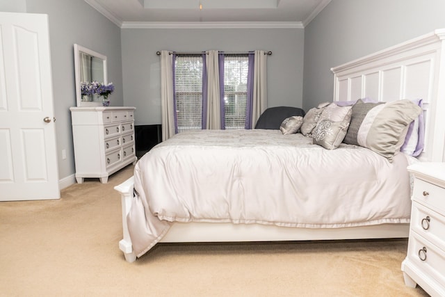 bedroom with light colored carpet, ornamental molding, and a tray ceiling