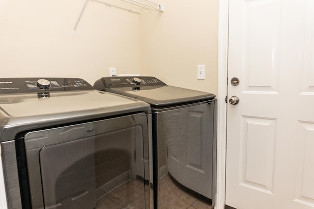 clothes washing area with separate washer and dryer and light tile patterned floors