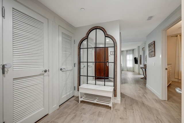 hallway with light hardwood / wood-style flooring