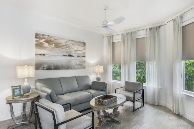 living room featuring ceiling fan and light wood-type flooring