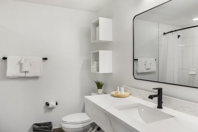 bathroom featuring vanity, toilet, and a shower with shower curtain