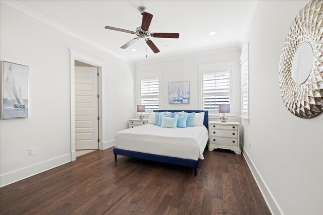 bedroom featuring crown molding, dark hardwood / wood-style floors, and ceiling fan