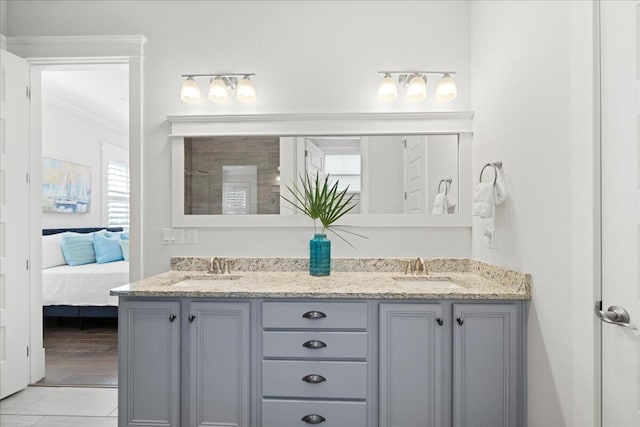 bathroom with ornamental molding and vanity