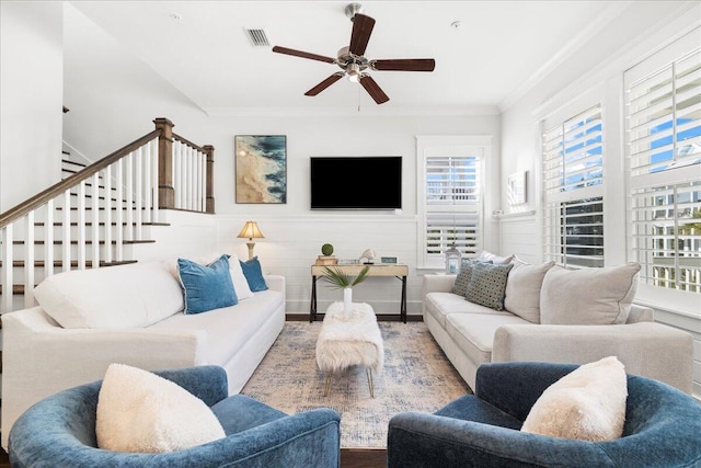 living room featuring ornamental molding and ceiling fan