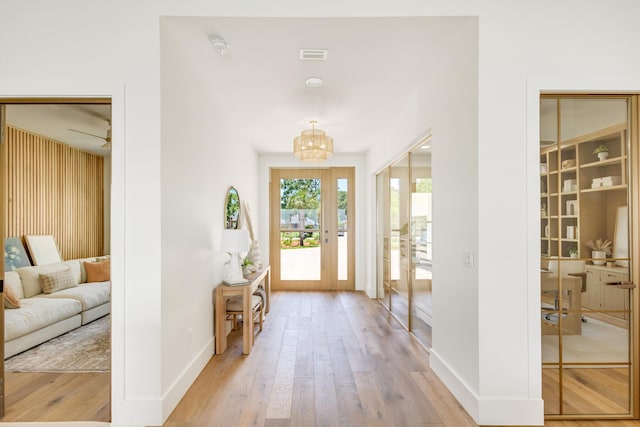 foyer with an inviting chandelier and light hardwood / wood-style floors