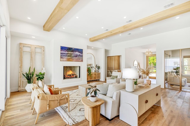 living room featuring light hardwood / wood-style flooring and beamed ceiling