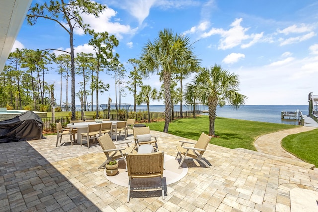 view of patio featuring area for grilling and a water view