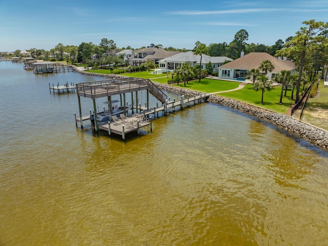 dock area featuring a water view and a lawn