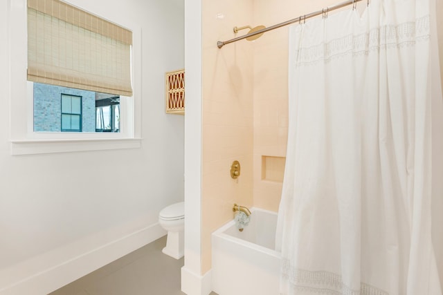 bathroom with shower / tub combo and toilet