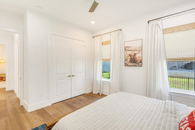 bedroom featuring a closet, ceiling fan, and light wood-type flooring