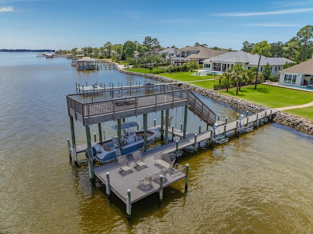 view of dock with a water view and a yard