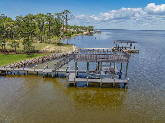 view of dock featuring a water view and a lawn