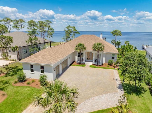 view of front of house with a water view and a garage