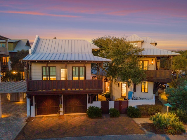 view of front of property with a garage and a balcony