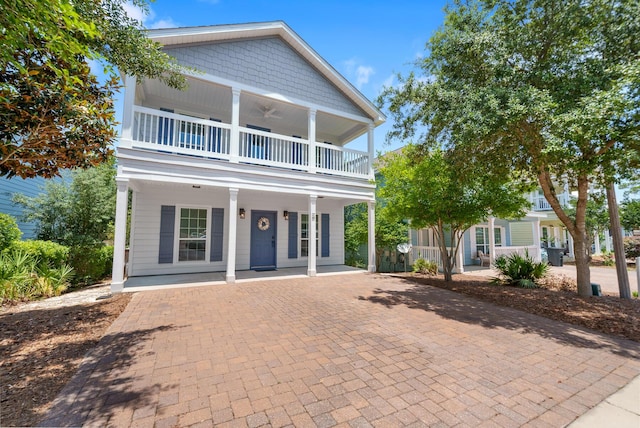 view of front of property with ceiling fan, a balcony, and a porch